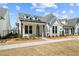 Beautiful new construction home with white siding, a manicured lawn, and a cozy front porch at 505 Godfrey Dr, Cumming, GA 30040