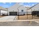 Modern, white home featuring a two-car garage with a black metal gate around the property at 505 Godfrey Dr, Cumming, GA 30040
