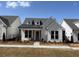 Charming single-story home featuring a black metal roof accent, white siding, and a well-maintained lawn at 505 Godfrey Dr, Cumming, GA 30040