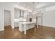 Modern kitchen features an island, stainless steel appliances, white cabinets and pendant lighting at 505 Godfrey Dr, Cumming, GA 30040