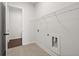 Laundry room featuring tile flooring, washer hookups, and wire shelving at 505 Godfrey Dr, Cumming, GA 30040