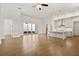 Open-concept living room with hardwood floors and seamless flow to the modern kitchen at 505 Godfrey Dr, Cumming, GA 30040