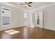 Bright bedroom featuring hardwood floors, tray ceilings, and natural light from two windows at 505 Godfrey Dr, Cumming, GA 30040