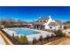 Beautiful community pool with a stylish clubhouse in the background on a clear, sunny day at 505 Godfrey Dr, Cumming, GA 30040