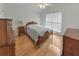 Cozy bedroom with a decorative bed frame, wood floors, and natural light at 3076 Harris Mill Ct, Duluth, GA 30096