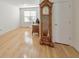 Light-filled bedroom with wood floors, window, and a traditional grandfather clock at 3076 Harris Mill Ct, Duluth, GA 30096