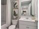 Bathroom with a large mirror, shower with tub and white vanity offering storage space at 5895 Mattan Trl, Lithonia, GA 30058