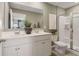 Modern bathroom featuring a double sink vanity, large mirror, and glass-enclosed shower at 5895 Mattan Trl, Lithonia, GA 30058