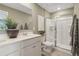 Modern bathroom featuring double sinks, white cabinets, an enclosed glass shower, and a large mirror at 5895 Mattan Trl # 68, Lithonia, GA 30058