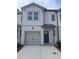 Modern two-story townhome with gray siding, attached garage, and concrete driveway at 5895 Mattan Trl, Lithonia, GA 30058