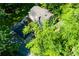 Aerial view of a charming home nestled among lush green trees at 3125 Lakeside Dr, Cumming, GA 30041