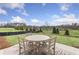 Outdoor dining on the patio perfect for outdoor gatherings, facing a green and well-kept community space at 159 Park Ln, Fairburn, GA 30213