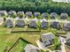 Aerial view showcasing homes with fenced yards in a serene, green neighborhood at 90 Piedmont Cir, Covington, GA 30016