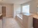 Bathroom featuring a soaking tub with tiled walls, tiled floor, and a vanity with sink at 90 Piedmont Cir, Covington, GA 30016