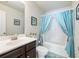 Light and airy bathroom with a shower/tub combo and blue curtains at 90 Piedmont Cir, Covington, GA 30016