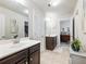 Bathroom with double vanity, dark brown cabinets, and a view of bedroom at 90 Piedmont Cir, Covington, GA 30016