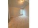 Neutral carpeted bedroom with bright window and modern ceiling light at 90 Piedmont Cir, Covington, GA 30016