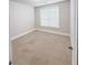 Neutral bedroom features a carpeted floor and bright natural light from a window at 90 Piedmont Cir, Covington, GA 30016