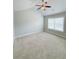 Bright bedroom with a ceiling fan, carpeted floor, and a large window at 90 Piedmont Cir, Covington, GA 30016