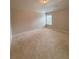 Carpeted bedroom with neutral colors and a bright window at 90 Piedmont Cir, Covington, GA 30016