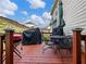 Deck with seating area, grill, and umbrella, overlooking the backyard at 90 Piedmont Cir, Covington, GA 30016