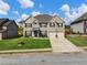 Two story brick home with a manicured lawn and driveway at 90 Piedmont Cir, Covington, GA 30016