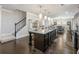 Large kitchen with island, dark cabinets, and hardwood floors at 90 Piedmont Cir, Covington, GA 30016