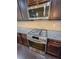 Close-up of the stainless steel range and microwave, complemented by dark cabinets and granite countertops at 90 Piedmont Cir, Covington, GA 30016