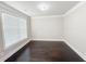 Bright living room featuring hardwood floors and neutral walls, offering a versatile space for any decor style at 90 Piedmont Cir, Covington, GA 30016