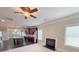 Open living space combining kitchen and fireplace, enhanced by dark wood floors and warm lighting at 90 Piedmont Cir, Covington, GA 30016