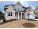 Two-story house with light brick exterior, gray shutters, and a landscaped lawn at 1077 Sweet Mia Ln, Powder Springs, GA 30127