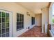 Covered balcony with terracotta tile flooring and architectural column detail at 211 Colonial Homes Dr # 2304, Atlanta, GA 30309
