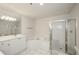 Bathroom with jacuzzi tub, walk in shower, large mirror and white cabinets at 211 Colonial Homes Dr # 2304, Atlanta, GA 30309
