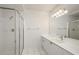 Bathroom featuring shower, white cabinets, sink and a long mirror with elegant lighting at 211 Colonial Homes Dr # 2304, Atlanta, GA 30309