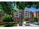 Brick apartment building with well-maintained landscaping and ample parking at 211 Colonial Homes Dr # 2304, Atlanta, GA 30309