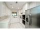 Well-lit kitchen features white cabinets and modern stainless steel appliances at 211 Colonial Homes Dr # 2304, Atlanta, GA 30309