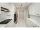 The long galley kitchen has white cabinets and tile floors at 211 Colonial Homes Dr # 2304, Atlanta, GA 30309