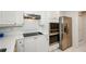 Bright kitchen features stainless steel refrigerator and appliances with white cabinets and tile flooring at 211 Colonial Homes Dr # 2304, Atlanta, GA 30309