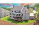 Two-story home with gray roof, large deck, and beautifully landscaped yard at 5693 Brendlynn Dr, Suwanee, GA 30024