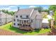 Luxury home with two-tiered deck and private backyard; elegant stone exterior at 5693 Brendlynn Dr, Suwanee, GA 30024