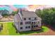 House with gray roof, large deck, and beautifully landscaped backyard at 5693 Brendlynn Dr, Suwanee, GA 30024