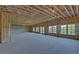 Unfinished basement with high ceilings and large windows at 5693 Brendlynn Dr, Suwanee, GA 30024
