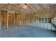 Unfinished basement with framing for future rooms at 5693 Brendlynn Dr, Suwanee, GA 30024