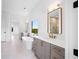 Elegant bathroom featuring a freestanding tub and dual vanities at 5693 Brendlynn Dr, Suwanee, GA 30024