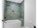Bathroom with shower and tiled bathtub at 5693 Brendlynn Dr, Suwanee, GA 30024