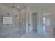 Large bathroom with walk-in shower, herringbone tile floor, and linen closet at 5693 Brendlynn Dr, Suwanee, GA 30024