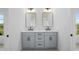 Double vanity bathroom with contemporary mirrors at 5693 Brendlynn Dr, Suwanee, GA 30024