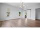 Bright bedroom with hardwood floors, multiple windows, and an attached bathroom at 5693 Brendlynn Dr, Suwanee, GA 30024