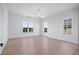 Spacious bedroom with hardwood floors, large windows, and a sliding barn door at 5693 Brendlynn Dr, Suwanee, GA 30024