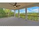 Spacious deck with a view of the wooded area, ceiling fan, and railings at 5693 Brendlynn Dr, Suwanee, GA 30024